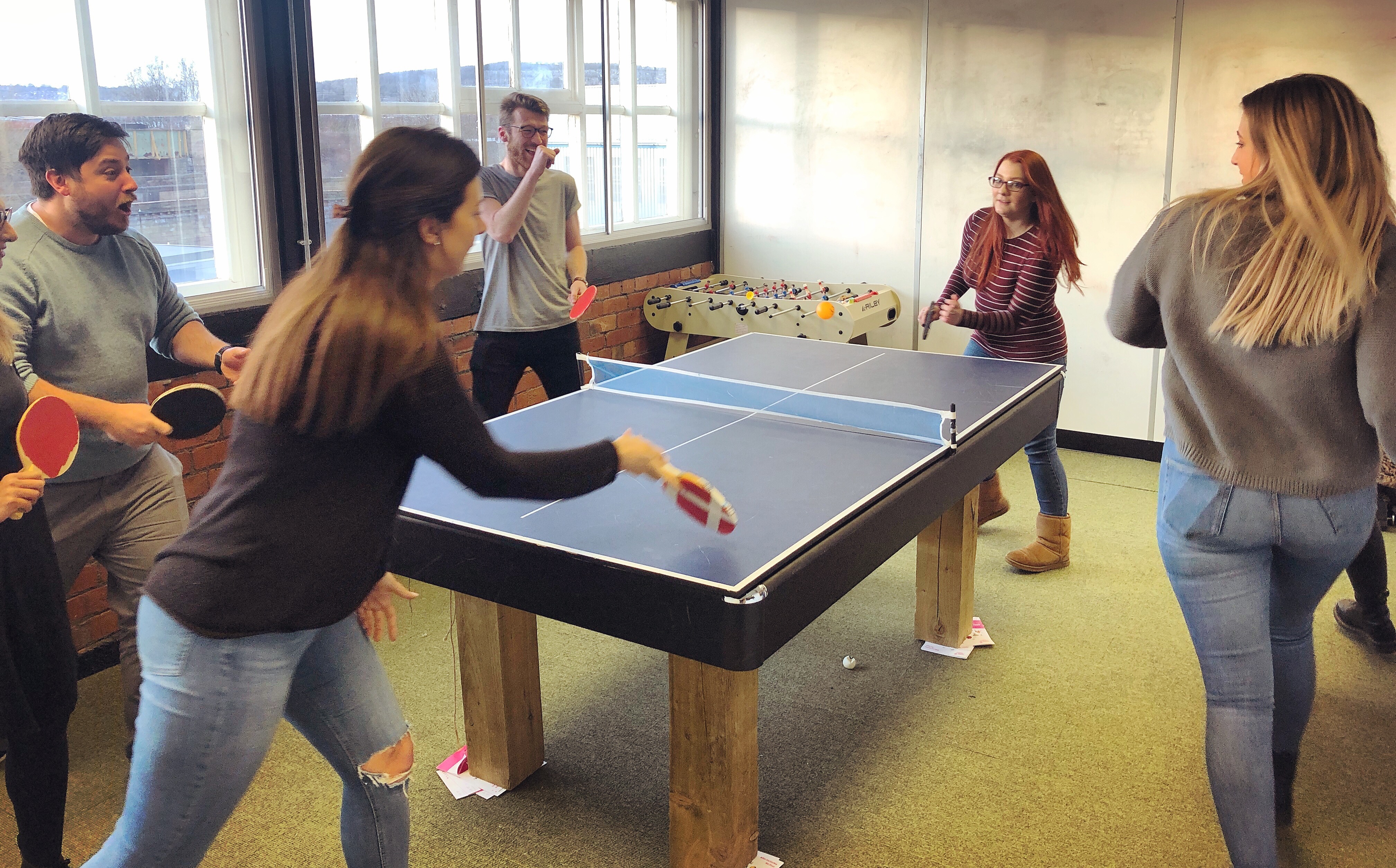 Photo of Split the Bills team playing ping pong
