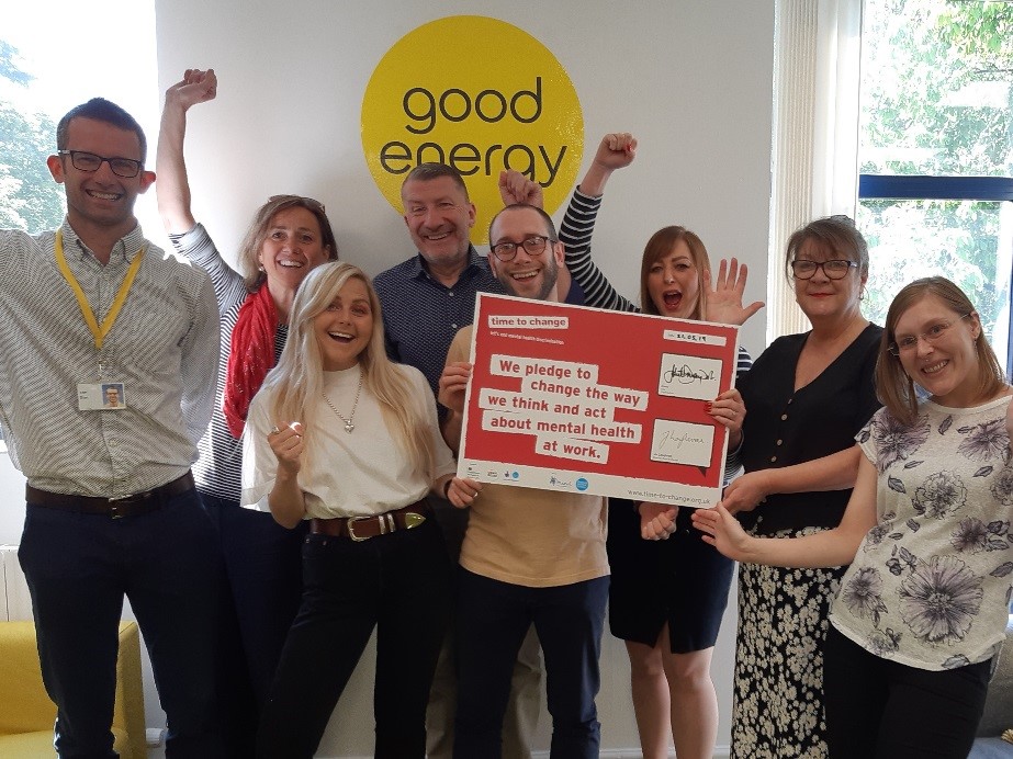 Staff at Good Energy holding a Time to Change Pledge sign