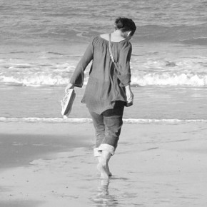 Black and white photo of a woman on the beach