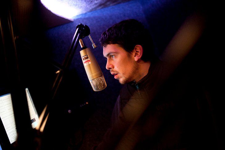 Man stood in from on microphone, photo by James Arthur Allen | A War Within