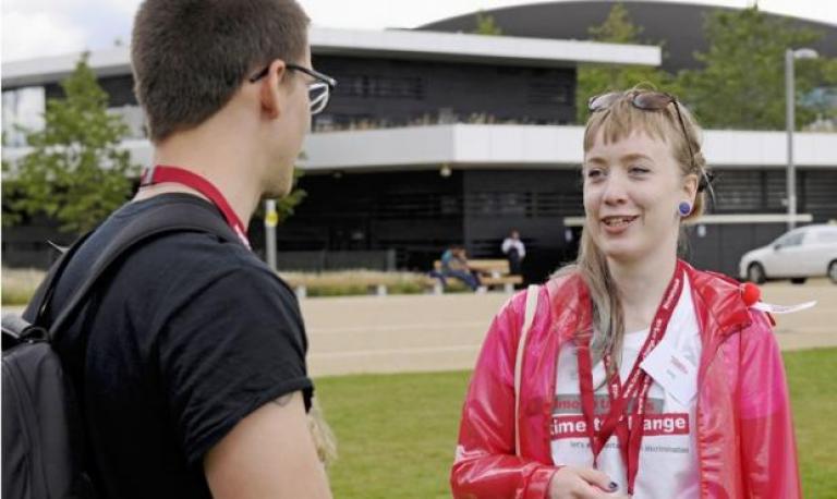 a woman in a Time to Change t-shirt talking to a man