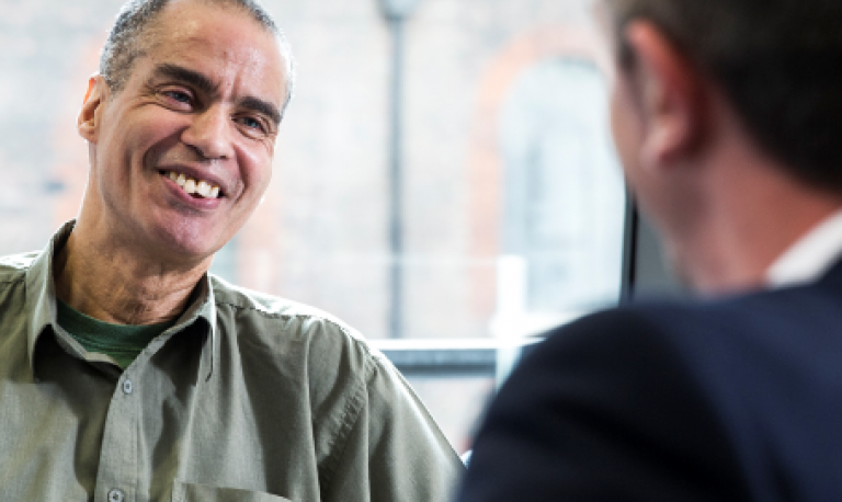 two men talking in a workplace setting